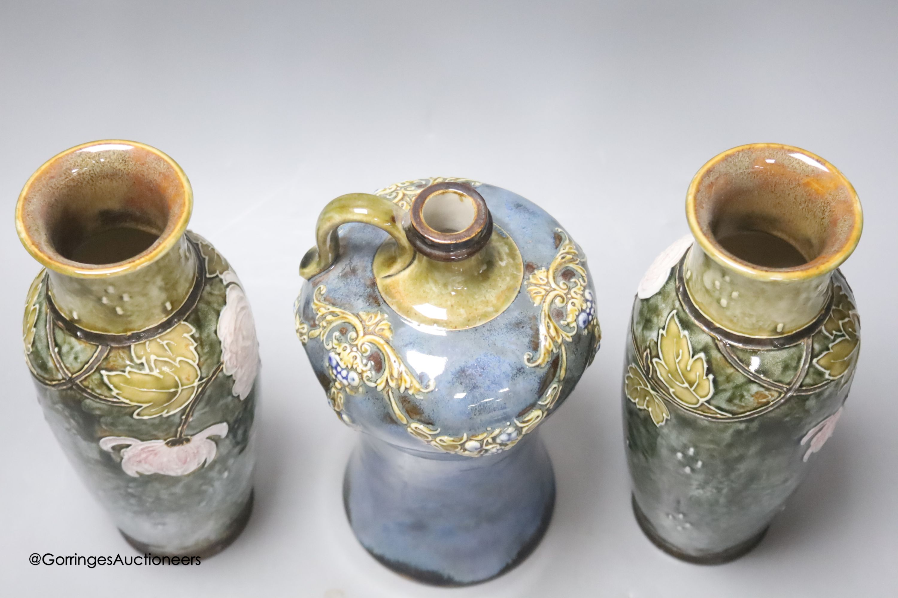 A pair of Doulton vases, 23cm high, together with a Doulton flask, 22cm high (3)